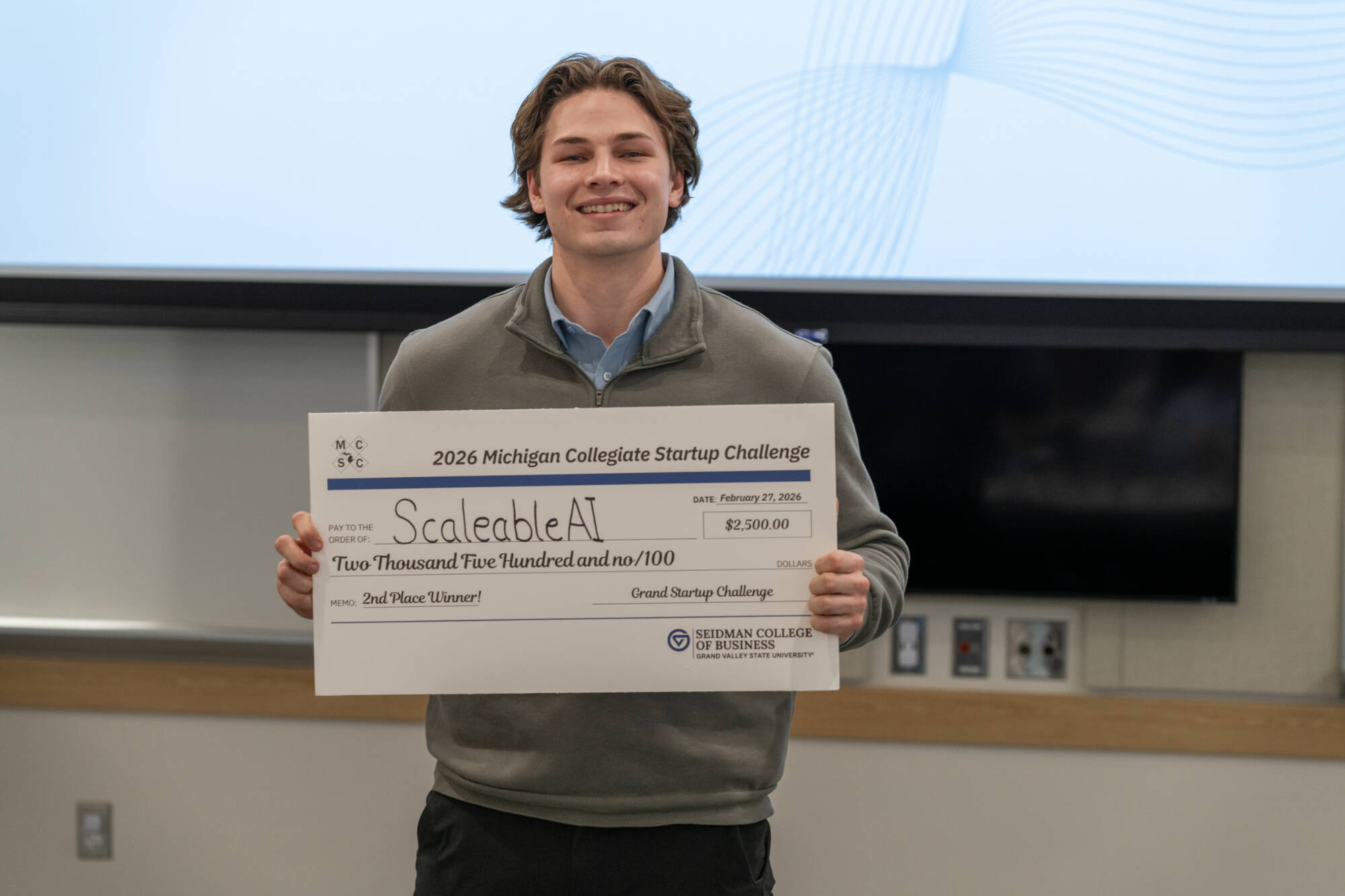 Representative of ScalableAI with their prize check